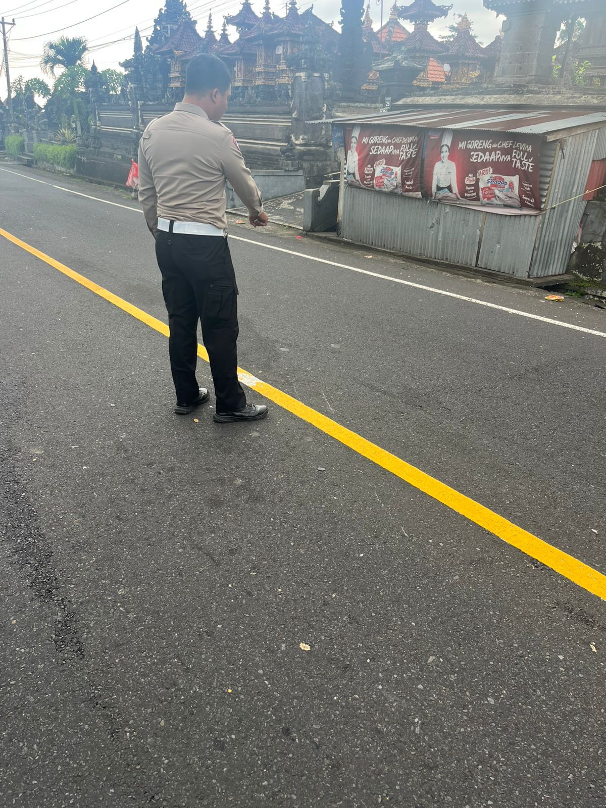 Polisi menunjukkan titik kecelakaan Vario vs pikap di Banjar Kukub, Desa Perean Tengah, Kecamatan Baturiti, Kabupaten Tabanan, Senin (20/10/2025)