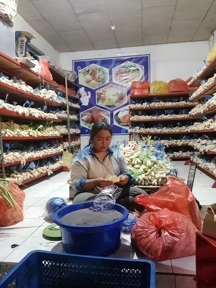 Yuli sedang mebungkus dodol di rumah produksi dodol di Desa Penglatan, Buleleng.