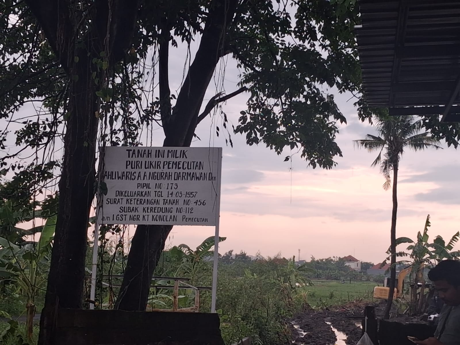 Plang dan alat berat (Ekskavator warna kuning) pihak lain berada di lahan yang disebut sudah dimenangkan oleh Puri Kaleran Kangin. (Bali Express/Istimewa)