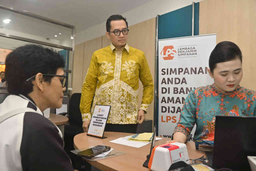 Kepala Kantor Perwakilan Lembaga Penjamin Simpanan (LPS) Wilayah II Surabaya Bambang S Hidayat (tengah) berbincang dengan nasabah Bank Perekonomian Rakyat (BPR) Kamadana 