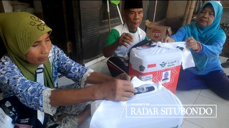 NAIK HAJI: Atimah dan suami bersiap-siap mengantarkan koper ke kantor Kemenag Situbondo, Rabu (22/5) lalu.