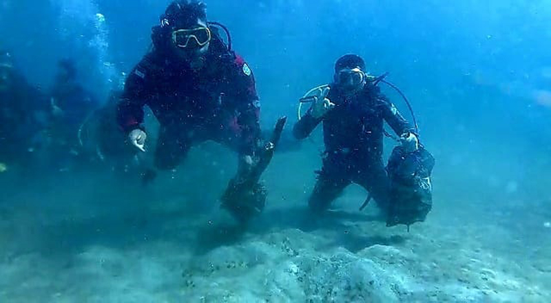 PUNGUT SAMPAH: Para pemuda membawa kantong yang berisi sampah di dasar laut Pasir Putih, Desa Pasir Putih, Kecamatan Bugatan, Situbondo, Minggu (9/6).