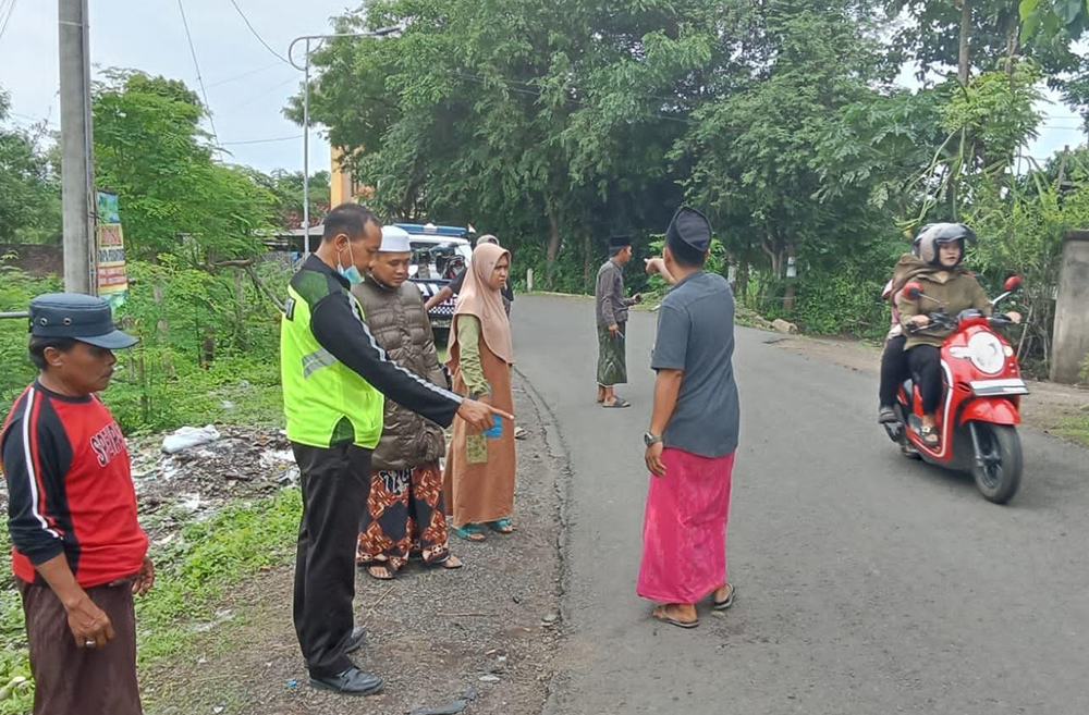 ADU BANTENG: Anggota Kanitlaka Polres Situbondo meninjau tempat kejadian perkara (TKP) di Jalan Desa Battal, Kecamatan Panji, Senin (16/12).