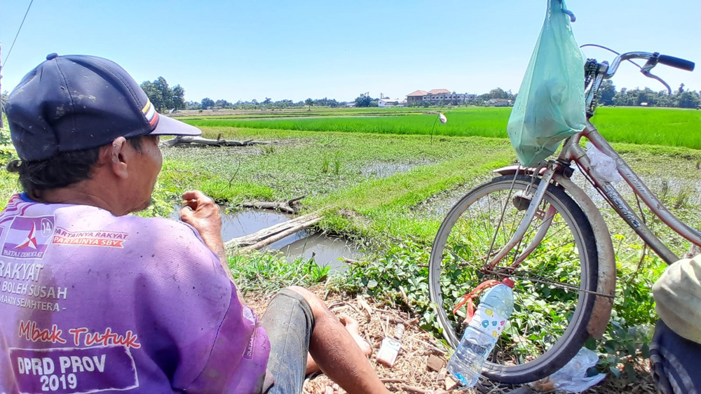 BIKIN RESAH: Sejumlah petani beristirahat di pinggir sawah milik Sujono,50, tepat di utara SPBU, Kecamatan Kapongan, Minggu (27/4).