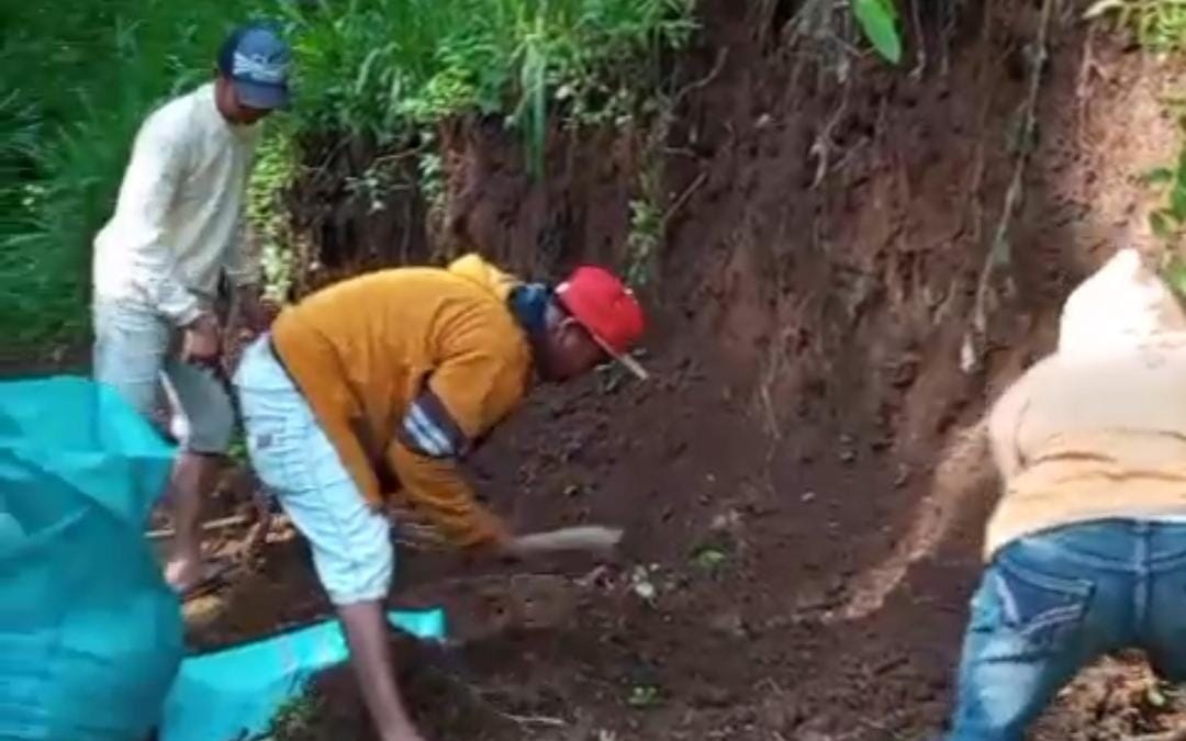 GOTONG ROYONG: Sejumlah warga menimbun jalan menuju Dusun Mendi, Desa Curahtatal, Kecamatan Arjasa, Kamis (1/5).