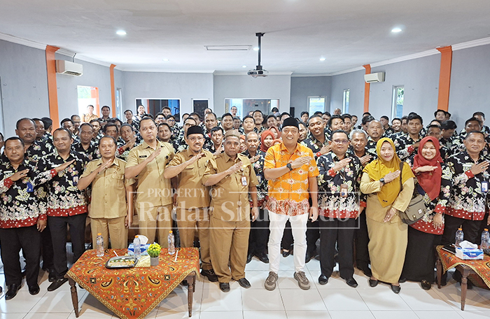 NAIK KELAS: Bupati Situbondo Yusuf Rio Wahyu Prayogo (delapan dari kiri) bersama Direktur Perumda Tirta Baluran, Asy&rsquo;ari (sembilan dari kiri) diikuti seluruh  karyawan foto bareng di aula Perumda.