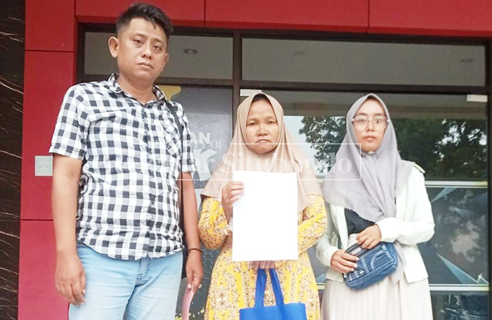TUNJUKKAN TANDA LAPOR: Maisurah, 44, warga Desa Sumberkolak, Kecamatan Panarukan, laporan ke SPKT Polres Situbondo, Rabu (11/30). 