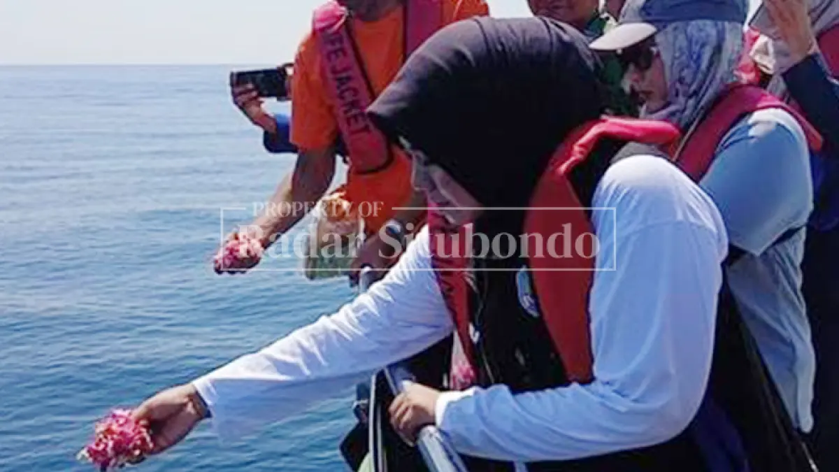 MOMEN SAKRAL: Wakil Bupati Situbondo Ulfiyah menaburkan bunga di tengah laut pelabuhan Jangkar, Minggu (29/3). (HUMAIDI/JPRS)