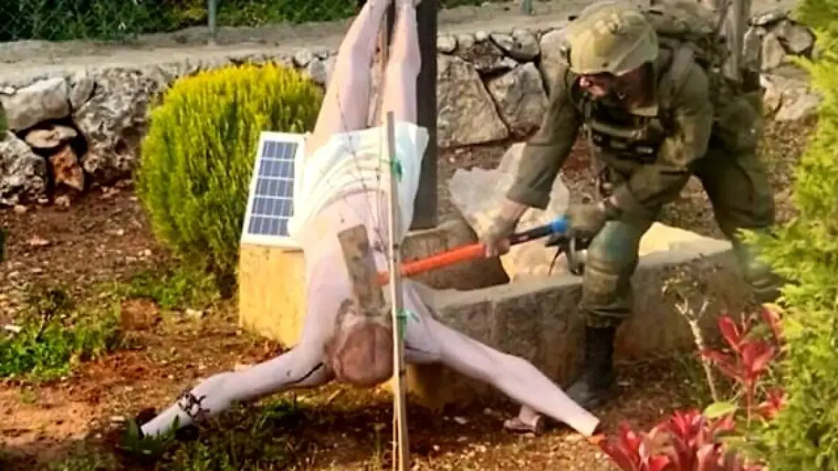 Seorang prajurit Israel Defense Forces (IDF) tampak menghancurkan patung Yesus Kristus di Lebanon selatan dalam gambar yang diunggah ke media sosial pada 19 April 2026. (The Times of Israel)