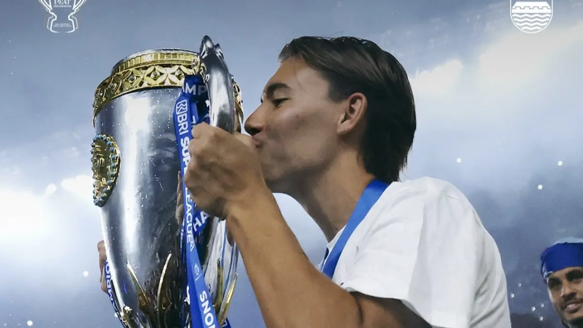 Dion Markk mencium piala pertamanya bersama Persib Bandung. (Instagram/persib)