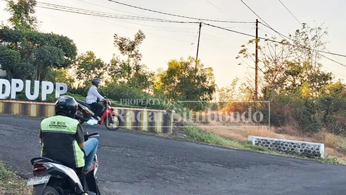 BERSEPEDA: Seorang ASN mengendarai sepeda motor memasuki Kantor Dinas PUPP Situbondo, Rabu (14/7). (Ahmad Rifa