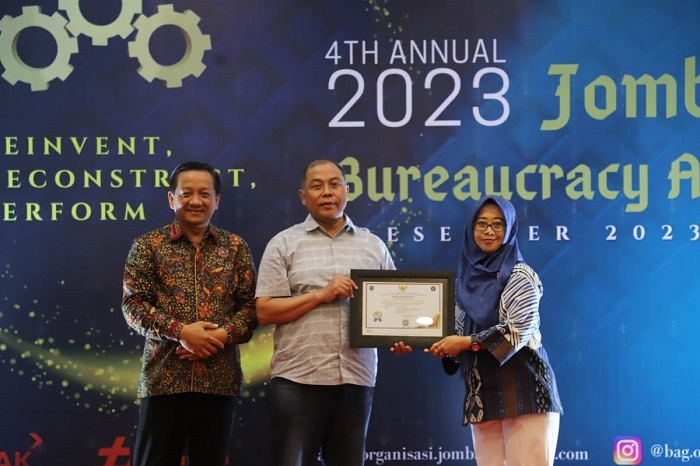 APRESIASI: Pj Bupati Jombang, Sugiat, didampingi Sekdakab Agus Purnomo menyerahkan piala best of the best pelayanan publik terbaik 2023 kepada Direktur RSUD Jombang, Dr dr Ma