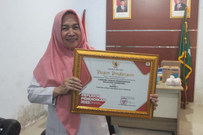 BANGGA: Kacabdindik Wilayah Jombang Sri Hartati menunjukkan  piagam penghargaan yang baru saja diterima dari Gubernur Jawa Timur, Selasa (19/12) lalu.