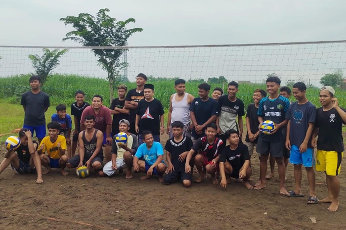 TELADAN: HM Syarif Hidayatullah ST MMT (Gus Sentot) memberikan bola voli kepada pegiat voli di Dusun Ngembeh, Desa Ngumpul, Kecamatan Jogoroto, Rabu (3/1).