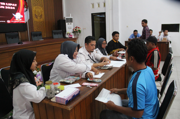 BERTAHAP: Petugas KPU Jombang melayani pembayaran ongkos sortir lipat surat suara Pemilu 2024 di kantor KPU Jombang, Kamis (18/1).