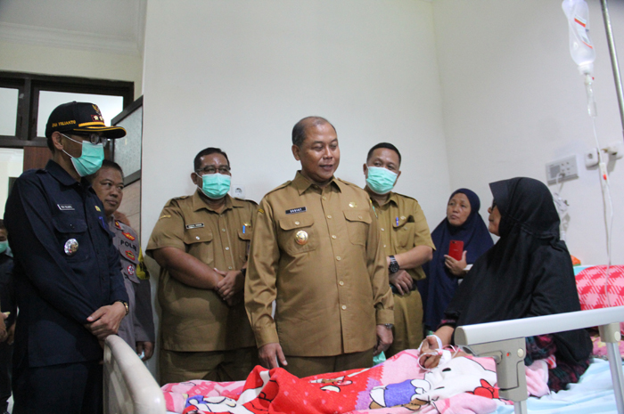 TELADAN: Pj Bupati Jombang Sugiat menjenguk Rohmawati, anggota KPPS asal Kesamben yang dirawat di RSUD Ploso, Senin (19/2).