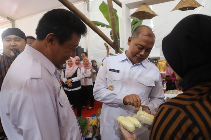 DICICIPI: Pj Bupati Jombang Sugiat bersama Kepala Disperta Jombang M Rony (kiri) mencicipi durian lokal Wonosalam binaan disperta.