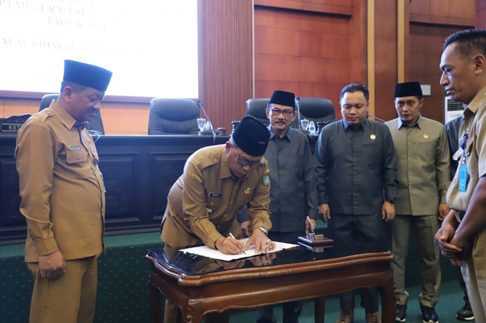 KOMPAK: Pj Bupati Sugiat menandatangani empat raperda inisiatif DPRD Jombang yang disahkan dalam paripurna.