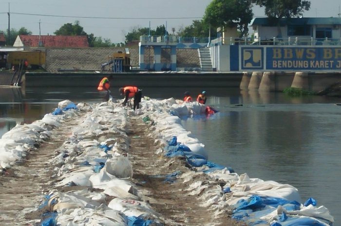 BAKAL DITINGGIKAN: Pemasangan jumbo bag untuk pembangunan kisdam di pintu enam Dam Karet Jatimlerek Jombang yang jebol.