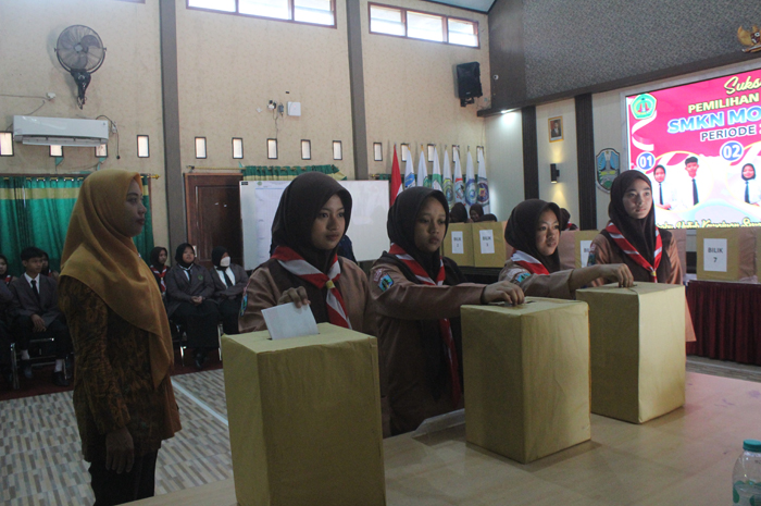 SUARA DEMOKRASI: Siswa SMKN Mojoagung, Jombang, memasukkan pilihannya ke kotak suara dalam pemilihan ketua OSIS.