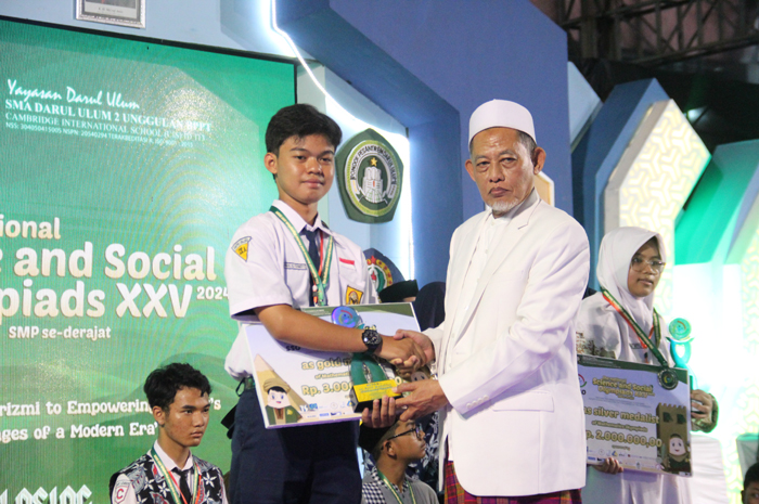 SELAMAT: KH Cholil Dahlan, Bendahara Umum MPPDU Rejoso,  menyerahkan piagam penghargaan kepada juara SSO ke-25 SMA Darul Ulum 2 Unggulan BPPT Jombang.