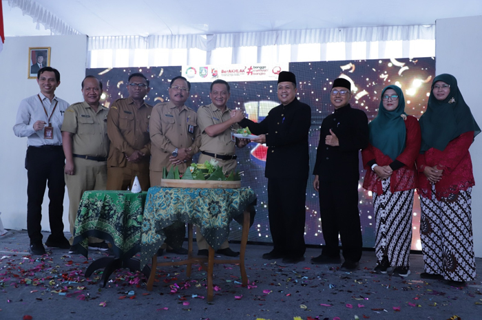 SELAMAT: Sekdakab Jombang Agus Purnomo (tengah) memberikan potongan tumpeng kepada Direktur RSUD Ploso dr Hendri Muzaki (hitam) dalam peringatan HUT ke-13, Selasa (13/12).