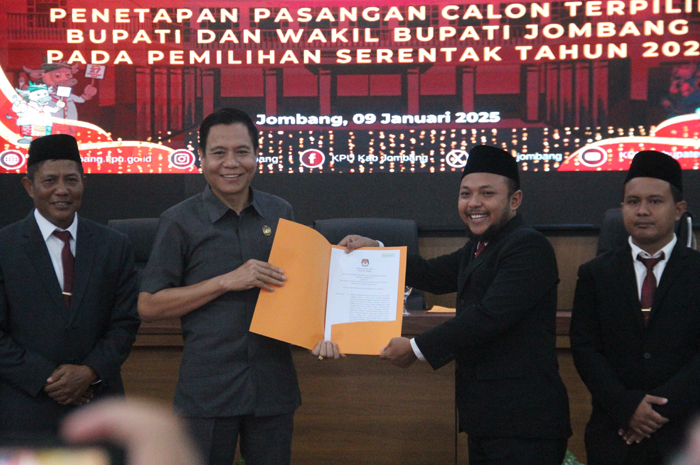 DISERAHKAN: Ketua KPU Jombang Ahmad Udi Masjkur menyerahkan SK salinan penetapan pasangan terpilih Bupati dan Wakil Bupati Jombang pada Pemilihan.serentak tahun 2024, Kamis (10/1).