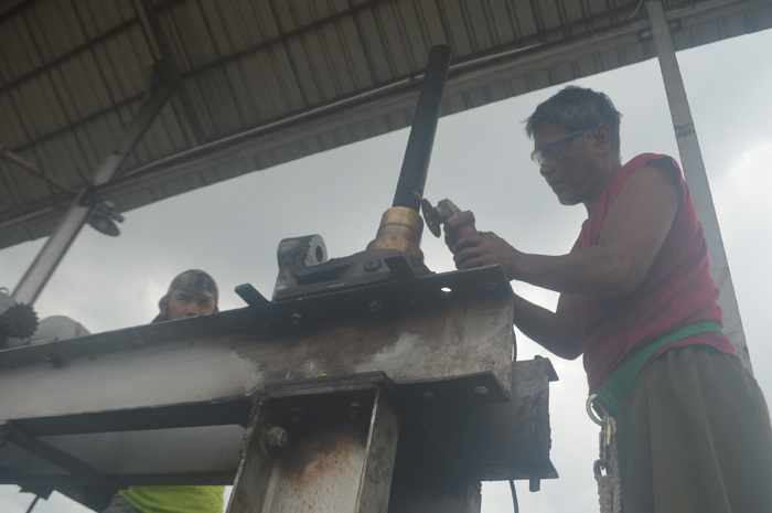 DIPERBAIKI: Petugas memperbaiki pintu air Dam Yani di Desa Budugsidorejo, Kecamatan Sumobito, Jombang.