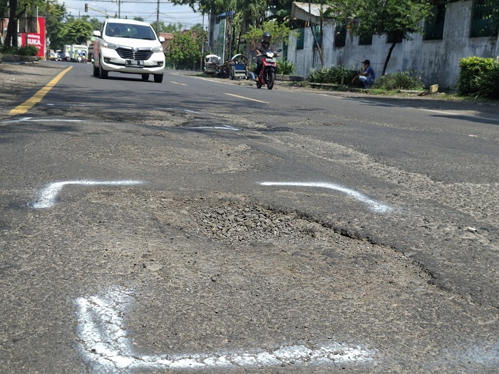 BERLUBANG: Kondisi jalan nasional di ruas Jl Brigjen Kretarto, Jombang yang baru saja ditambal rusak lagi, Minggu (2/3).