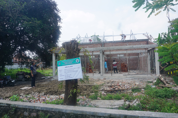 PENGGERAK PEREKONOMIAN: Kepala Desa Latsari Muslikan menunjukkan pembangunan kios desa dan gedung BUMDesa Latsari, Mojowarno, Jombang.