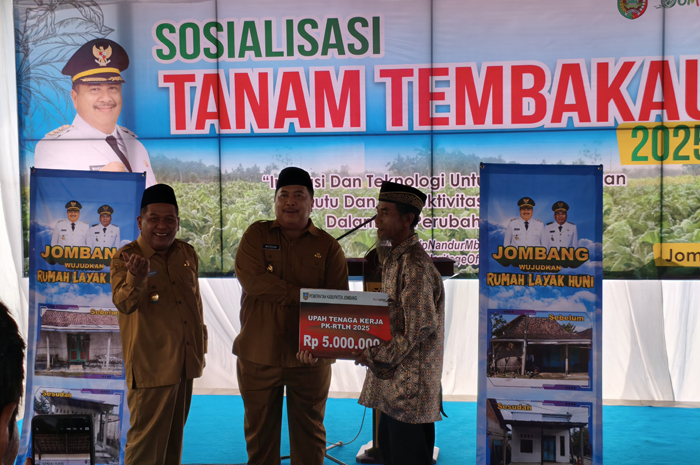 TELADAN: Bupati Warsubi bersama Wabup Salmanudin Yazid secara simbolis menyerahkan upah tenaga kerja PK-RTLH (peningkatan kualitas-rumah tidak layak huni) di Desa Tanjungwadung, Kecamatan Kabuh.