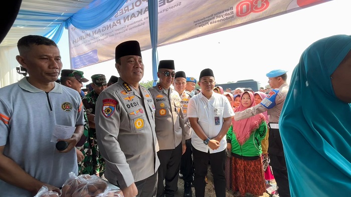 SINERGI: Pinca Bulog Mojokerto Muhammad Husin mendampingi Gubernur Jatim Khofifah Indar Parawansa menyalurkan SPHP di Kabupaten Jombang.