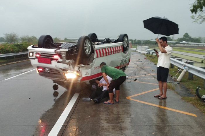 TERBALIK: Ambulans membawa penumpang yang terguling di Tol Jombang&ndash;Mojokerto KM 693+800 Desa Tengaran, Kecamatan Peterongan, Selasa (21/10) sore.