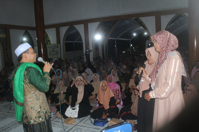 SENANG: Mbah Bolong memberikan hadiah kepada dua jamaah di Masjid Baitul Muttaqin, Desa Puri Semanding, Plandaan, Jombang, Senin (1/12).