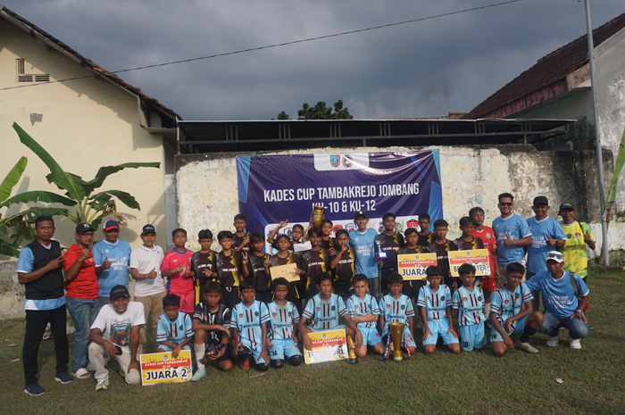 EVENT PERDANA: Kepala Desa Tambakrejo Mohammad Nasir Fadlillah bersama tim juara Kades Cup Tambakrejo Jombang kelompok usia 12 tahun didampingi panitia beserta para tamu.