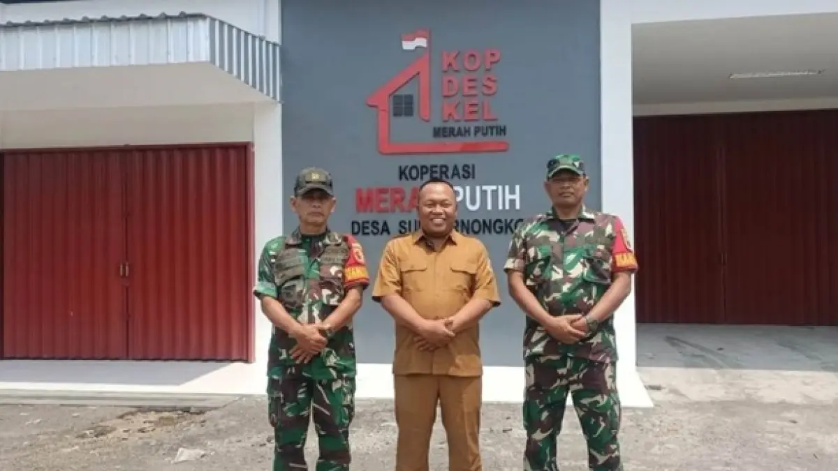 TELAH RAMPUNG: Kepala Desa Sumbernongko Sumartono bersama jajaran Koramil Ngusikan di depan gerai dan gudang KDKMP Sumbernongko, Ngusikan, Jombang. (Dwi Aris/Radar Jombang)