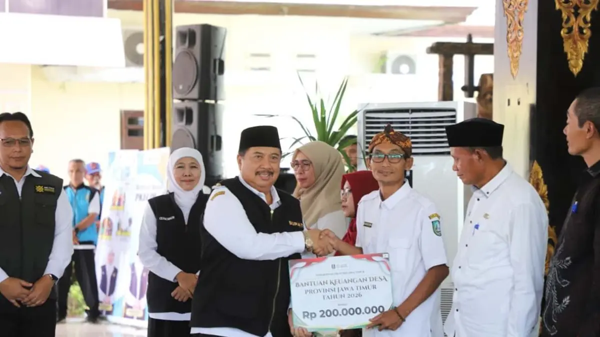 TINGKATKAN PELAYANAN: Kepala Desa Dukuhdimoro Muhammad Khoirul Umam saat menerima BK Pemprov Jatim secara simbolis dari Gubernur Jawa Timur Khofifah Indar Parawansa dan Bupati Jombang Warsubi di Pendopo Kabupaten Jombang, Selasa (11/3). (Dwi Aris/Radar Jombang)