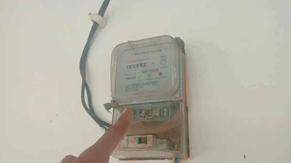 PADAM: Warga Desa Kwaron, Diwek, Jombang saat menunjukkan meteran PLN, (19/6). (Anggi Fridianto/Radar Jombang)
