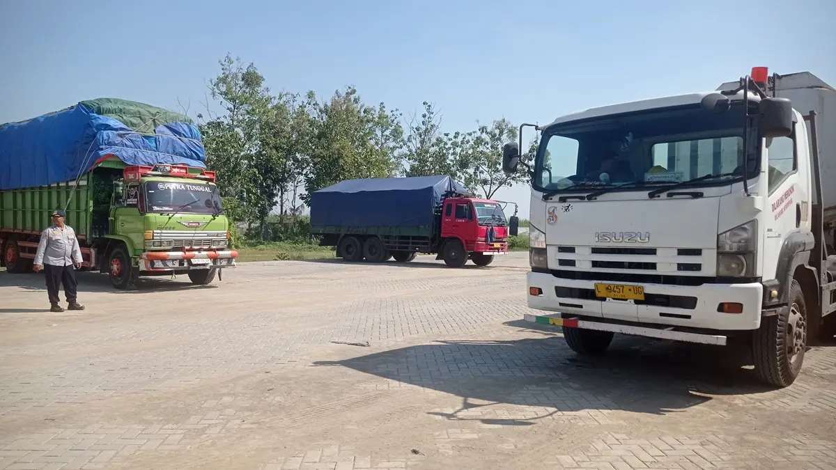 BEROPERASI: Kendaraan angkutan barang terparkir di parkir khusus Desa Glagahan, Kecamatan Perak, Jombang yang kini dikenakan tarif. (Ainul Hafidz/Radar Jombang)