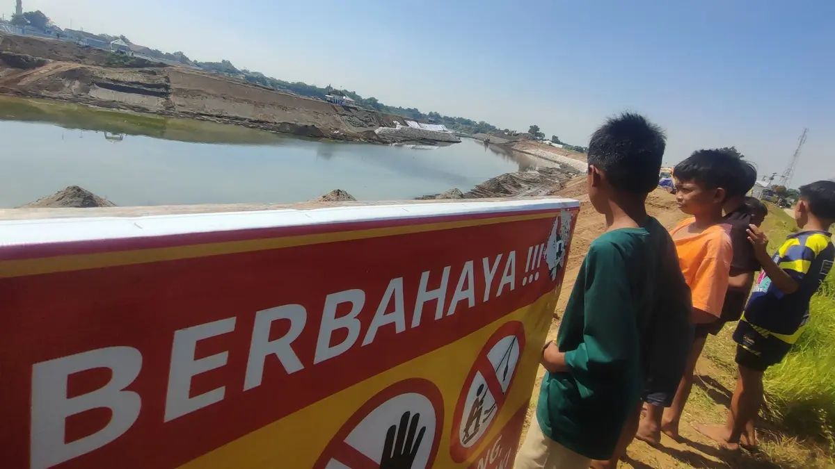 BELUM RAMPUNG: Warga melihat pekerjaan saluran pengelak proyek rehab Bendung Jatimlerek di sisi selatan atau Desa Sudimoro, Kecamatan Megaluh, Jombang. (Ainul Hafidz/Radar Jombang)