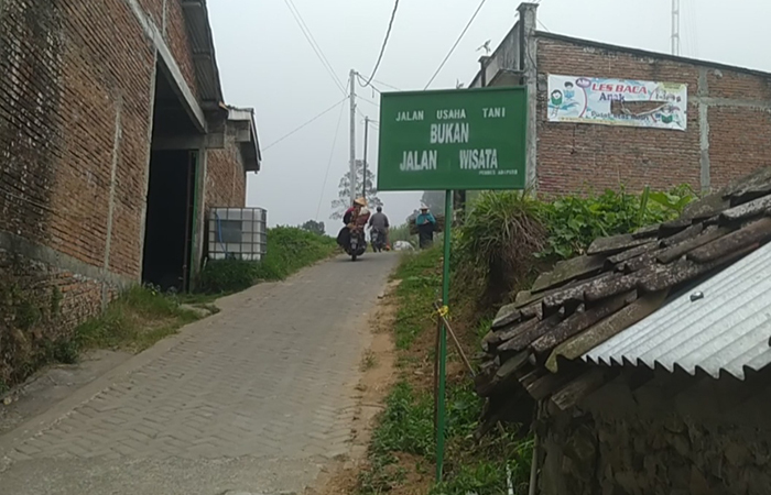 DIPASANG PAPAN: Warga Prampelan, Adipuro, Kaliangkrik resmi menutup akses jalan untuk wisatawan karena dinilai mengganggu aktivitas petani.Dok: Waluyo untuk Radar Jogja