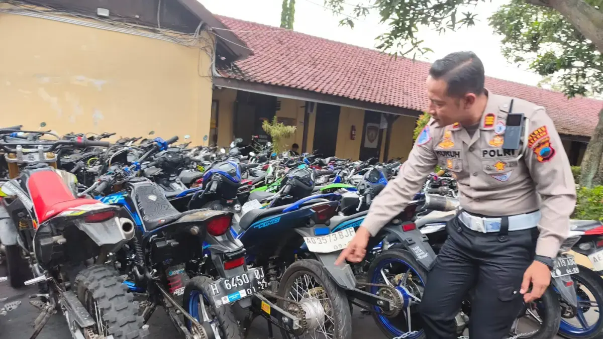 Kasatlantas Polres Sragen AKP Kukuh Tirto Satriyo Utomo tunjukkan sepeda motor berknalpot brong yang disita di mapolres, Senin (22/6). Ahmad Khairudin/Radar Solo