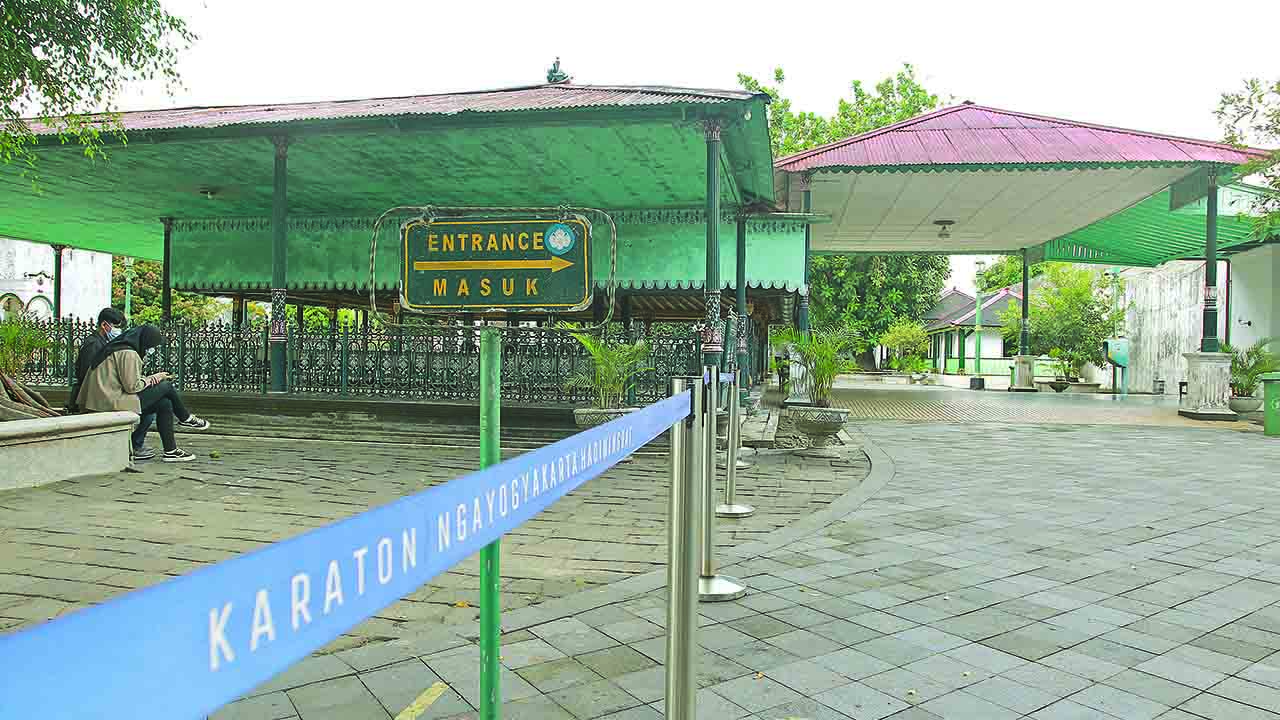 Abdi dalem melintas di area wisata Keraton Jogja yang ditutup sementara, Minggu (27/6). Itu atas perintah Raja Keraton Jogja karena meningkatnya kasus Covid-19.