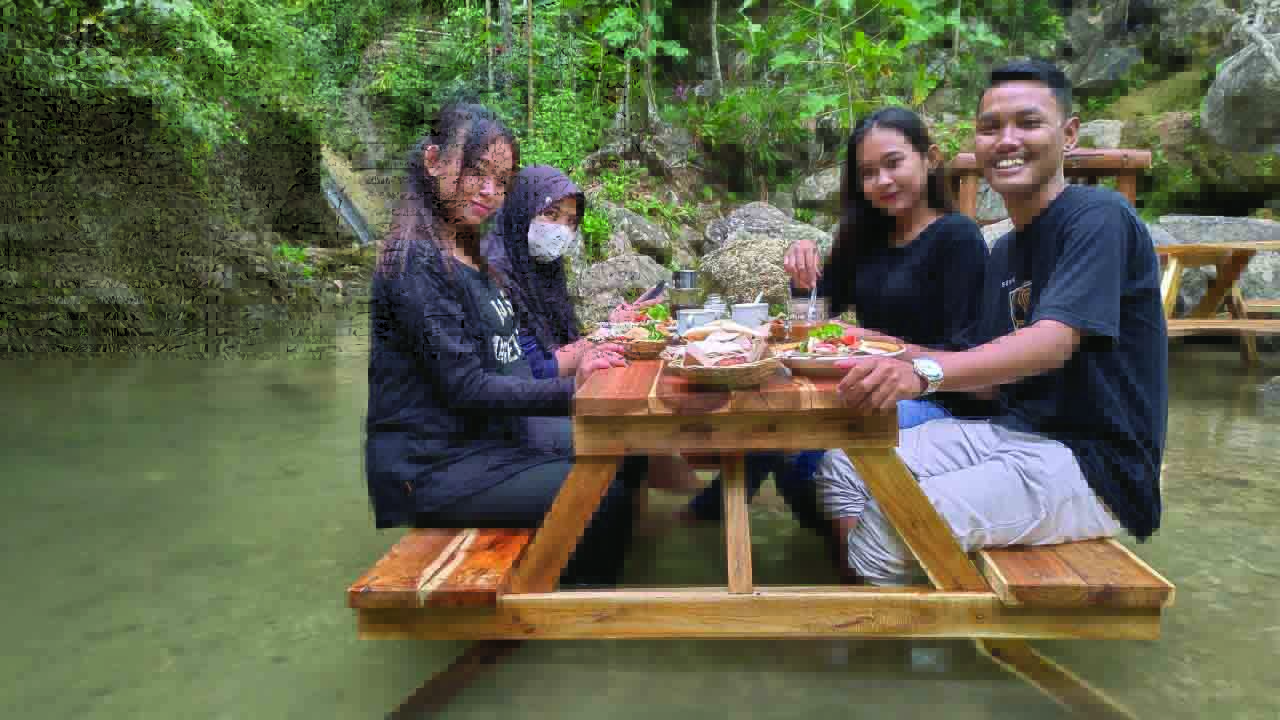 Pengunjung menikmati sensasi minum kopi di Kembang Kopi.Di sini pengunjung bisa merasakan sensasi ngopi dan menikmati kuliner sambil berendam aliran sungai.