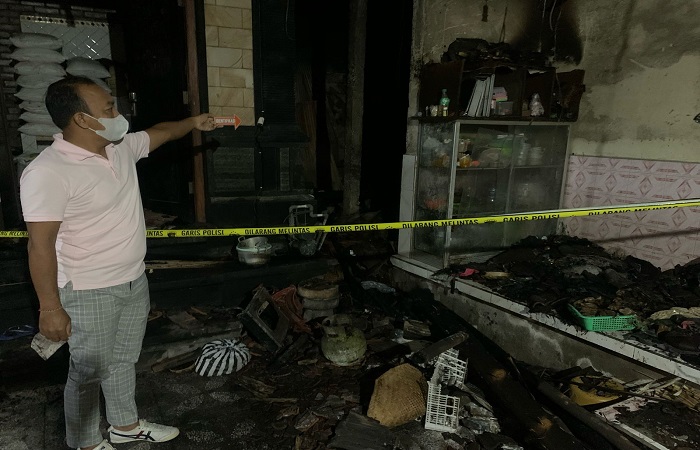 Polisi melakukan olah TKP di rumah milik Ketut Dani yang terbakar.