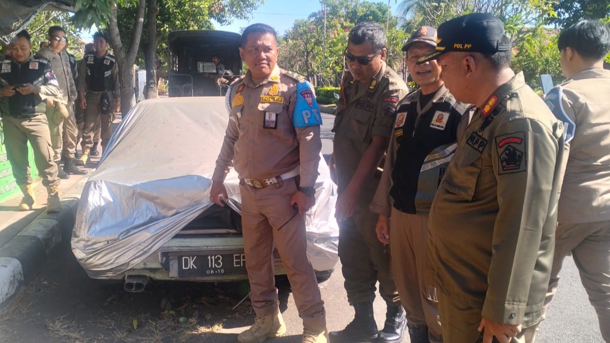 MELANGGAR: Pol PP Buleleng mendata mobil yang parkir selama berbulan-bulan di tepi jalan raya.