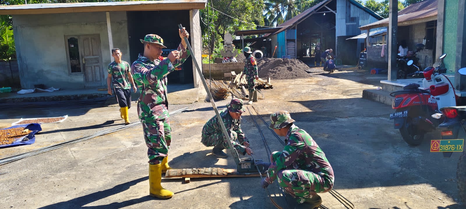 SIAPKAN AIR BERSIH: Personel TNI menyiapkan besi untuk membangun bak penampungan air bersih.