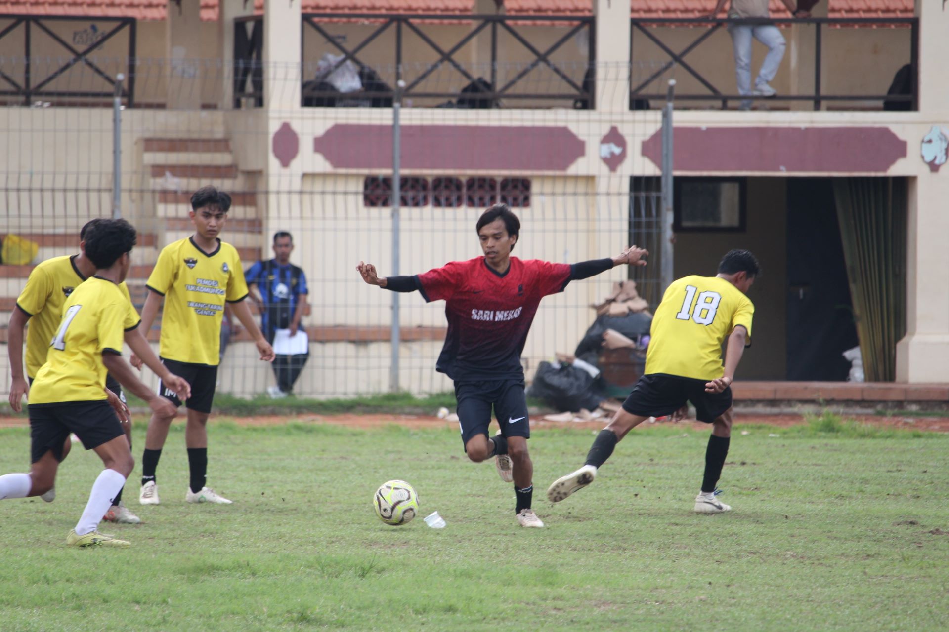 MAIN SANTAI: Pemain Putra Mas Pemuteran (merah) dikeliling pemain Padma Tukadmungga dalam pertandingan di Stadion Mayor Metra Singaraja, Selasa (16/12/2025).