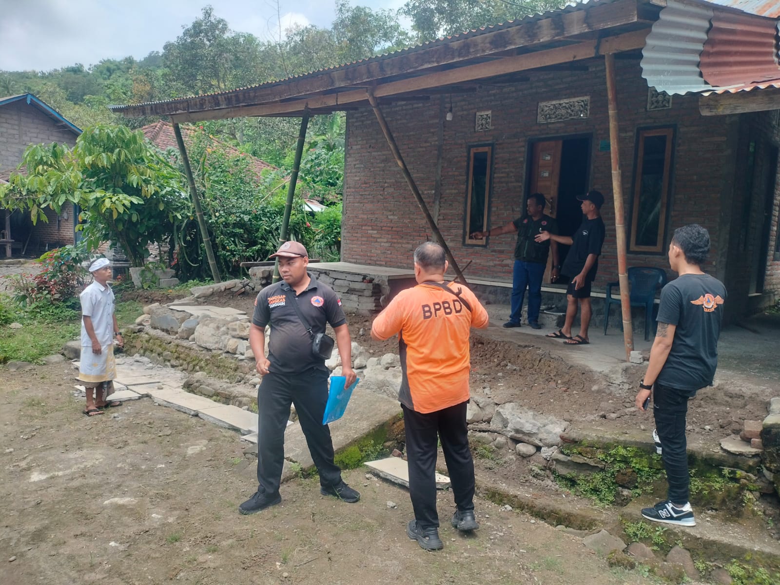 TERDAMPAK: BPBD Buleleng melakukan pengecekan terhadap rumah yang rusak akibat peristiwa tanah merayap atau soil creep di Desa Lokapaksa.