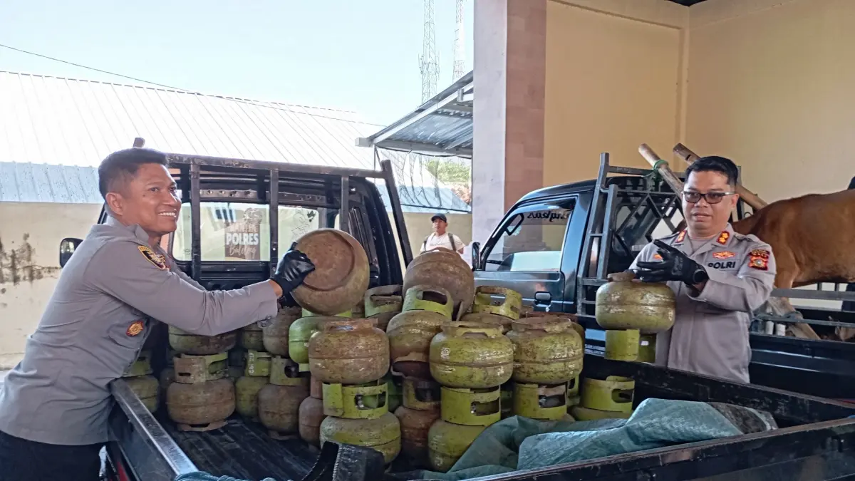 TUNJUKKAN BUKTI: Kapolres Buleleng, AKBP Ruzi Gusman (kanan) menunjukkan barang bukti tabung LPG subsidi yang diselewengkan. (Francelino Junior/Radar Buleleng)